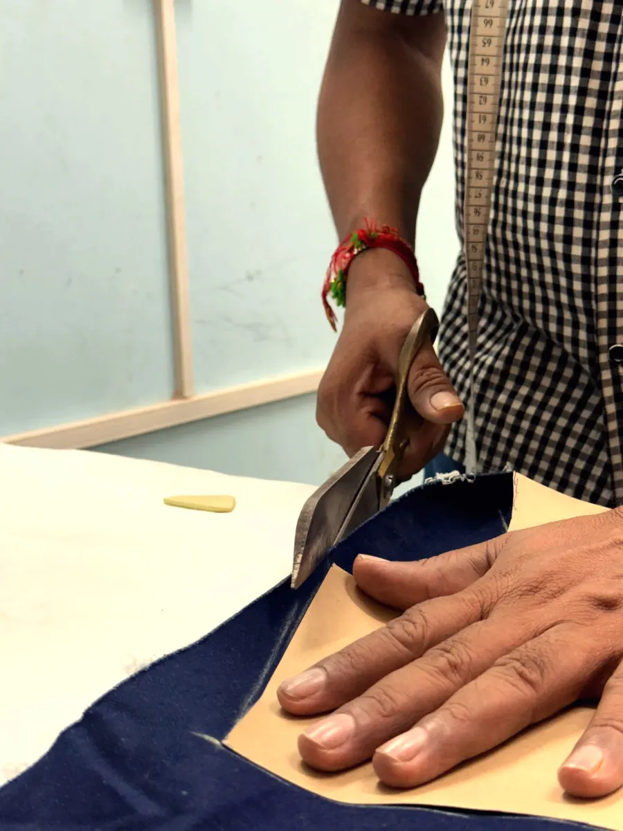 Close-up of hands cutting fabric with scissors